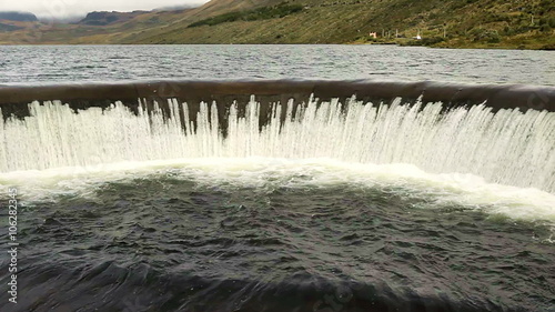 Discover the breathtaking beauty of Ecuador's Llanganates National Park with its iconic round dam nestled on the picturesque Pisayambo Lagoon. photo