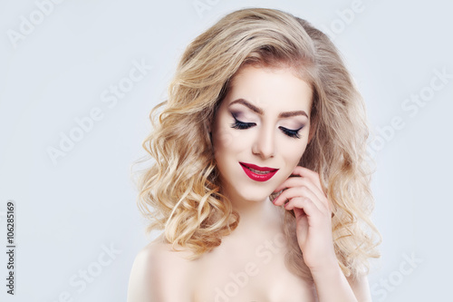 Blonde Hair Woman. Long Curly Hairstyle and Makeup