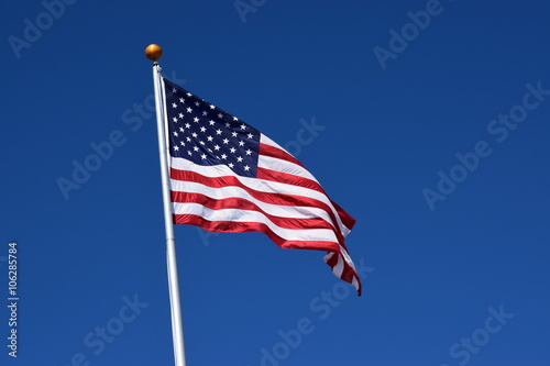 American flag waving in a clear blue sky