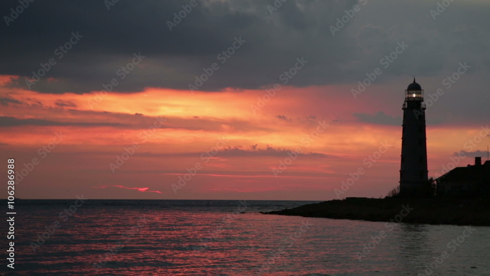 Lighthouse on the sea shore on and off at sunset
Lighthouse on the sea shore on and off at sunset