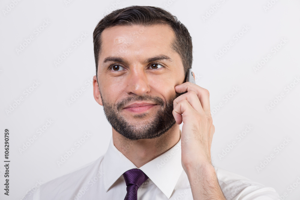 Young business man talks on his phone Young business man talks on his phone
