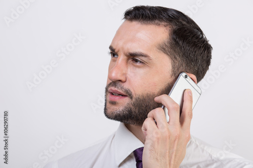 Young business man talks on his phone