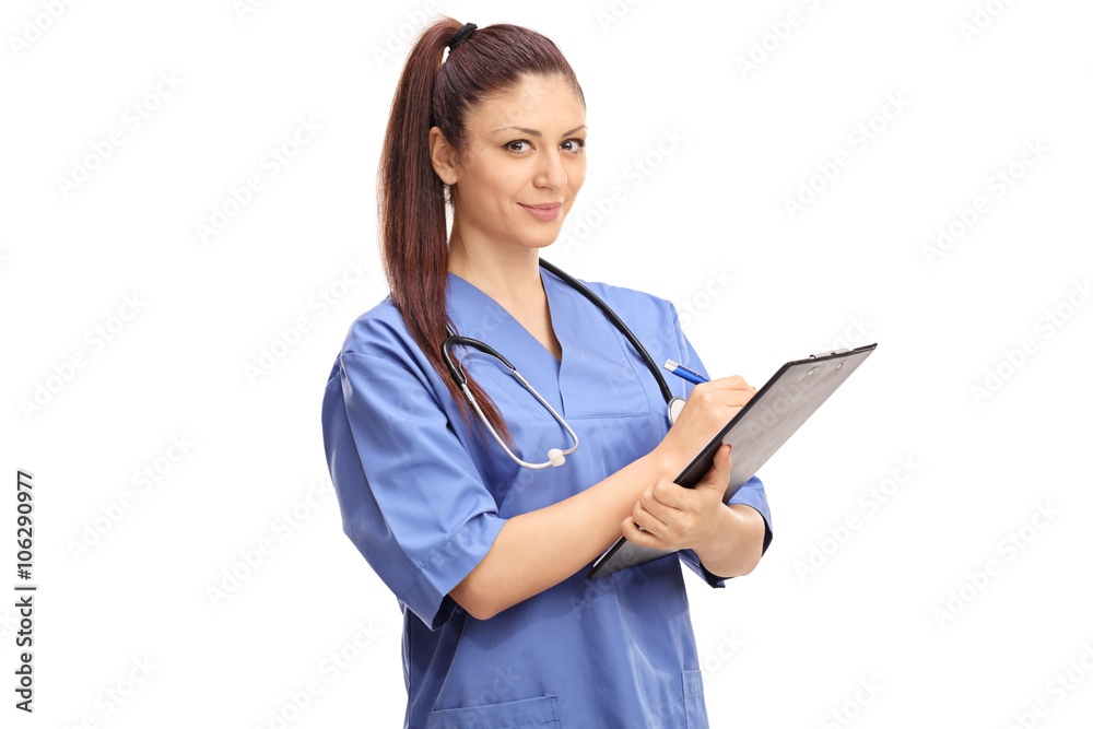 Female doctor writing on a clipboard Female doctor writing on a clipboard