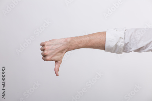 Hand with thumb down in a studio