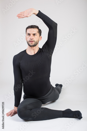 Young male performing yoga