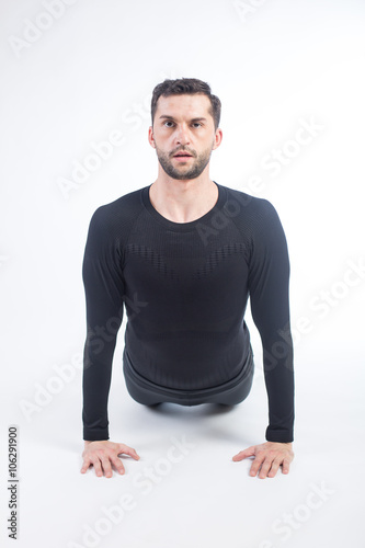 Young male performing yoga
