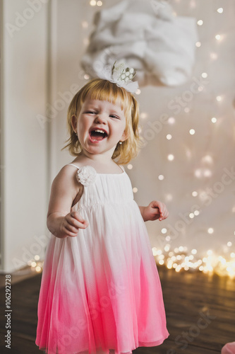 Happy child in a soft dress on the background lights 5429.