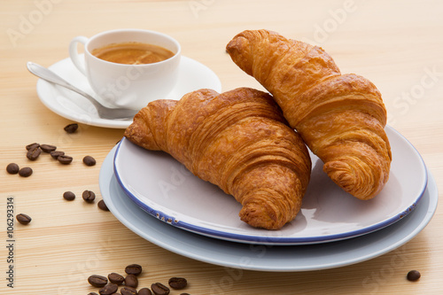 Delicious croissant with a cup of coffee