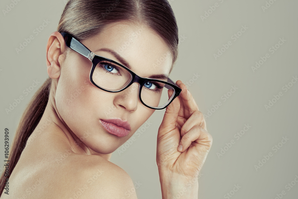 Clear vision concept. Beauty studio portrait of young pretty female wearing stylish eyeglasses with blank space. Clear vision concept. Beauty studio portrait of young pretty female wearing stylish eyeglasses with blank space.