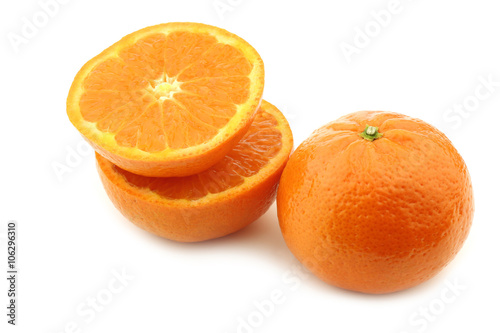 fresh tangerine and a cut one on a white background  