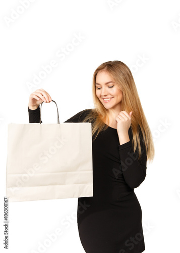 Young woman in a black dress with shopping bags, isolated on a w