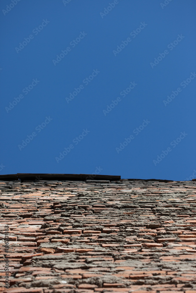 perspective of old red brick wall and blue sky perspective of old red brick wall and blue sky