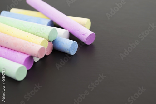 multicolored crayons on a black background
