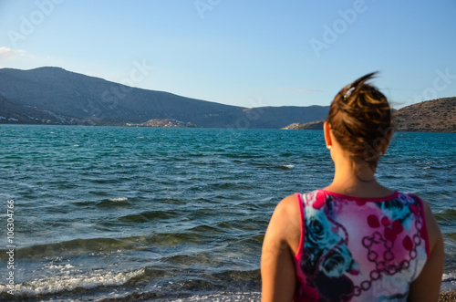 Dreamy girl is looking at the horizon with the beautiful mountains © Sergej Ljashenko