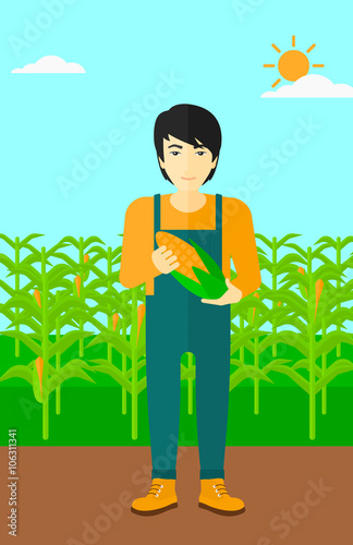 Farmer holding corn.