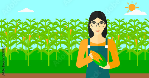 Farmer holding corn.