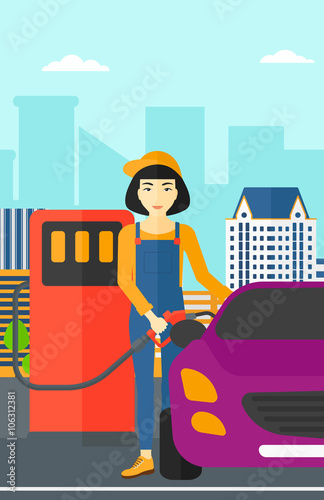 Woman filling up fuel into car.