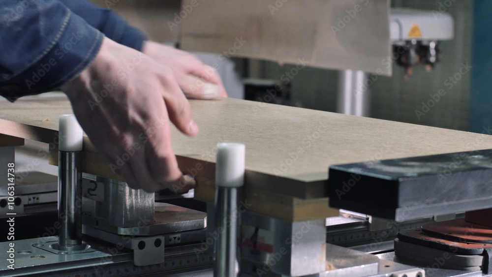 Worker blow the wood shavings away by air pistol and take the detail from the mill machine Worker blow the wood shavings away by air pistol and take the detail from the mill machine