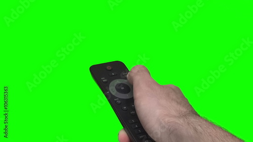 Wallpaper Mural Close up shot of a hand holding a telivision remote in front of a green screen Torontodigital.ca