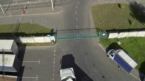 The truck drives through a sliding gate