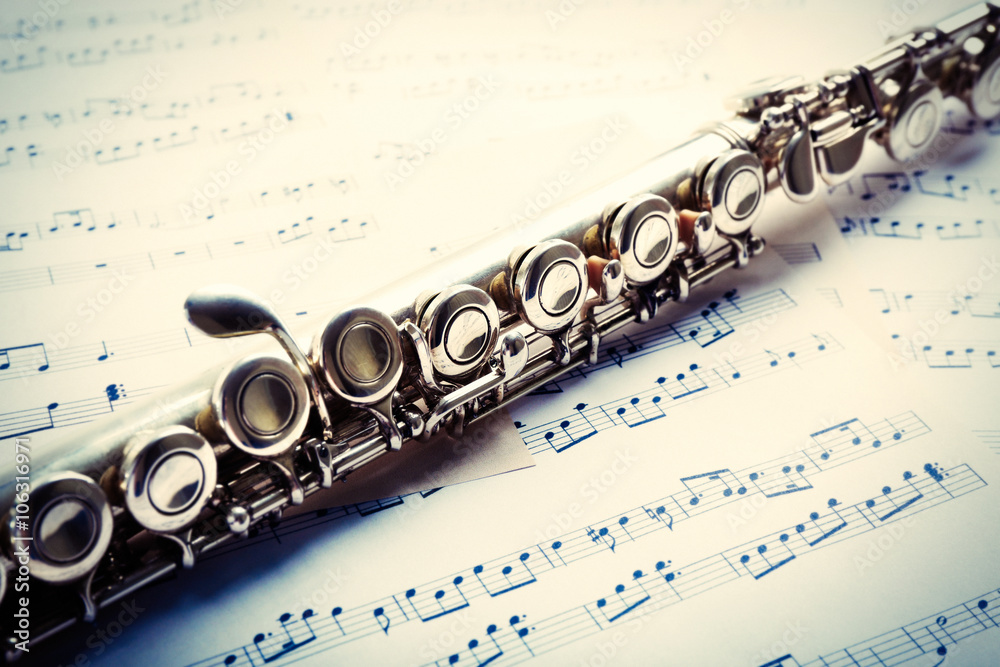 Fototapeta premium Flute on musical notes background