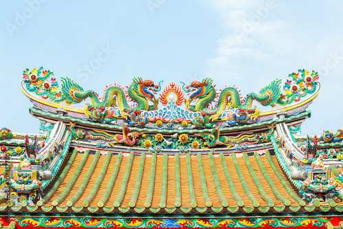 Two dragon sculpture Chinese style in the roof of Chinese temple. photo