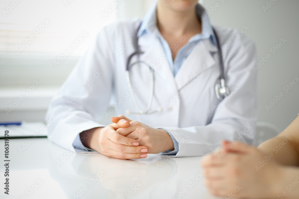 Doctor and patient are discussing something, just hands at the table Doctor and patient are discussing something, just hands at the table