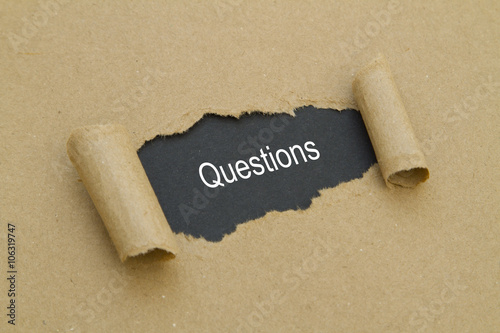 Tableau sur toile Questions word written under torn paper.