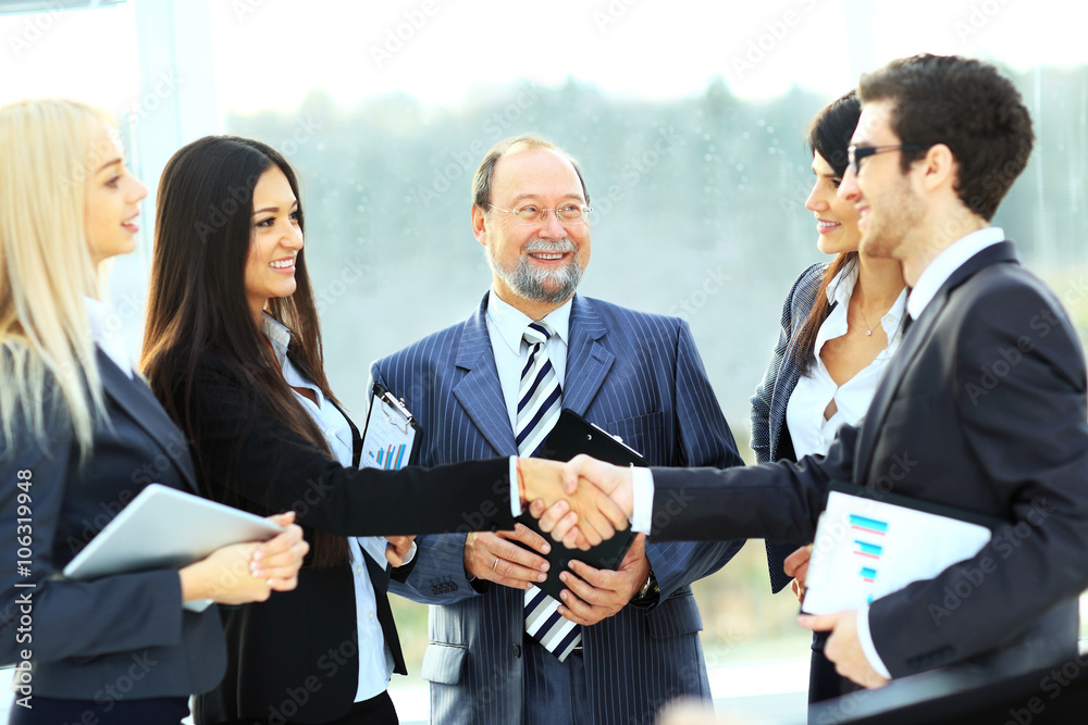 businessman and businesswoman shake hands