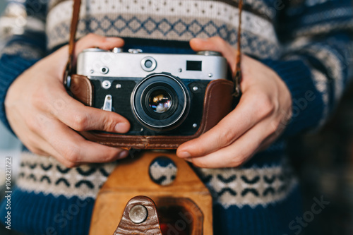 Man holding old retro camera in hands