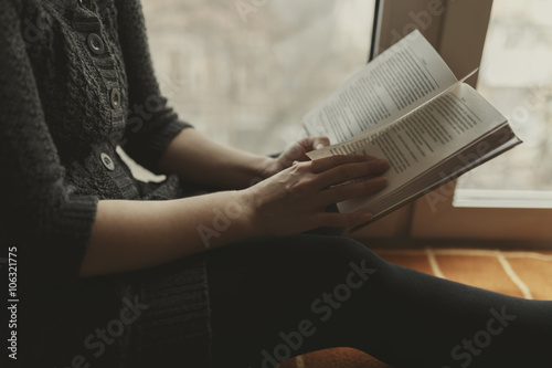 Woman read book seat on the plaid near window © Ivan Kurmyshov