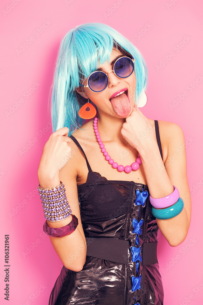 Funny pop girl portrait with stuck-out tongue