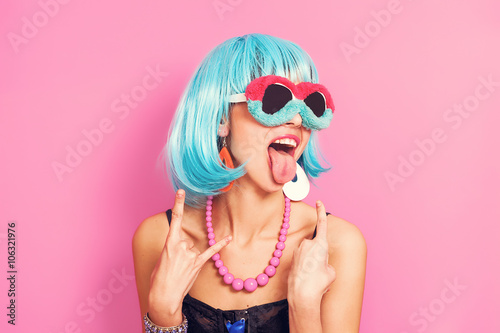 Pop girl portrait wearing weird sunglasses and blue wig