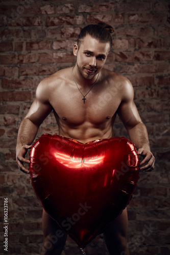 Young muscular man with heart