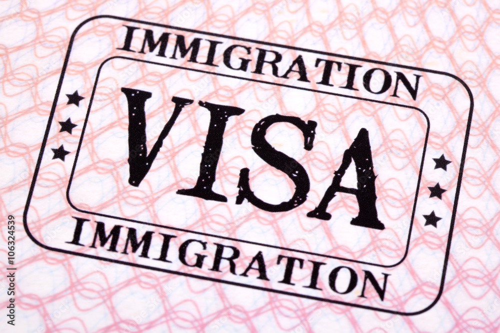 Immigration visa rubber stamp on a passport paper page photo Stock ...