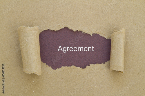 Agreement written under torn paper. photo