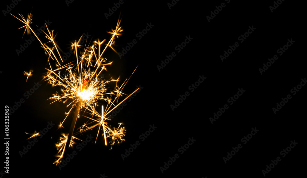 Christmas sparkler on black background. Bengal fire