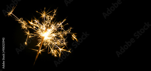 Christmas sparkler on black background. Bengal fire photo