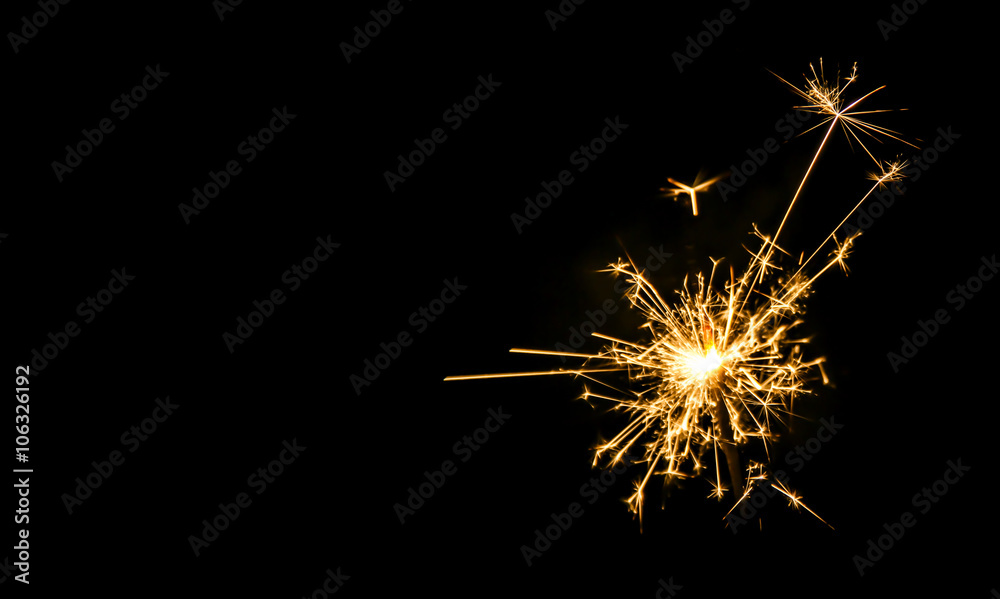 Christmas sparkler on black background. Bengal fire