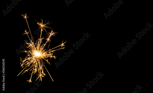 Christmas sparkler on black background. Bengal fire photo