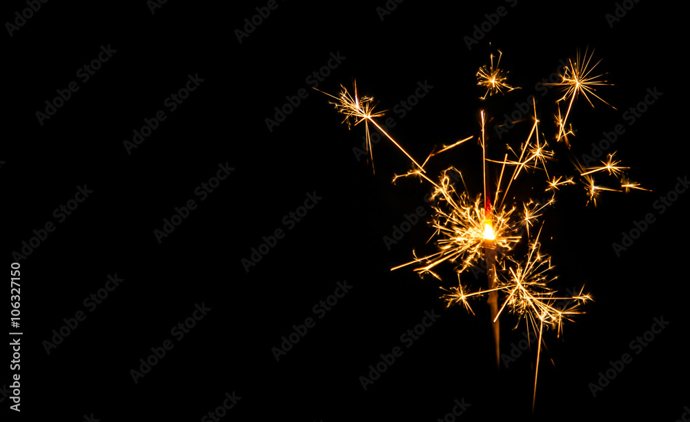 Fototapeta premium Christmas sparkler on black background. Bengal fire