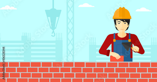 Bricklayer with spatula and brick.