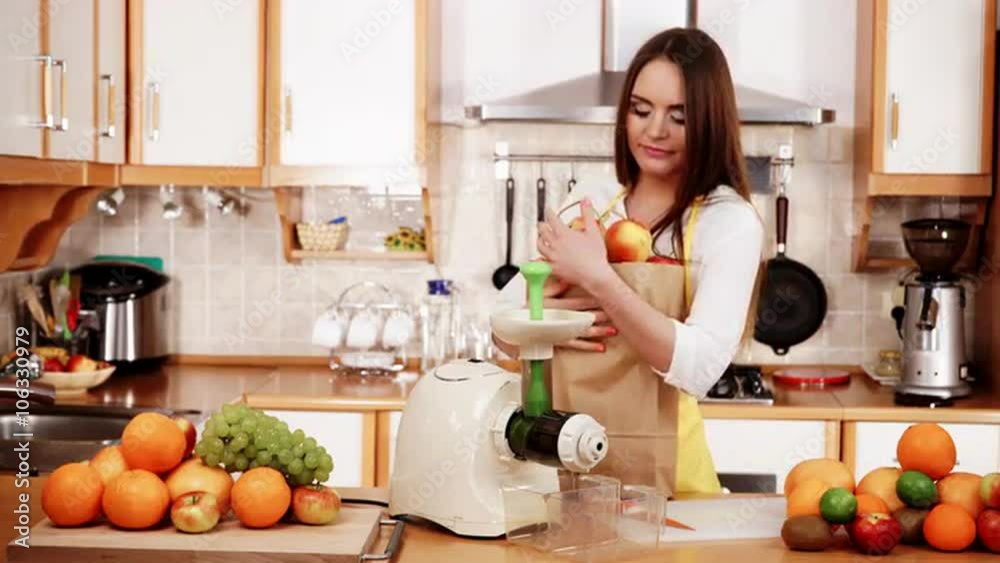Woman in kitchen preparing fruits for juicing 4K Woman in kitchen preparing fruits for juicing 4K