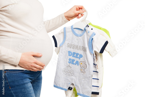 happy pregnant woman holing clothes of child