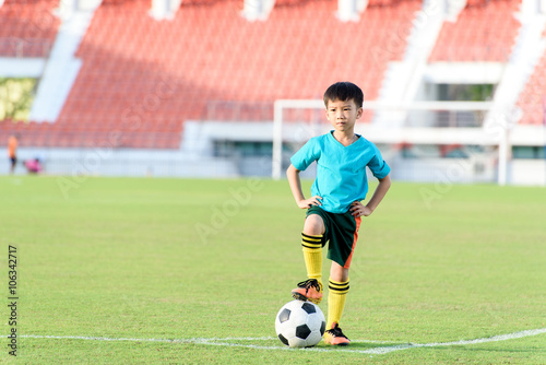 Boy and football in the football grass field © TinPong