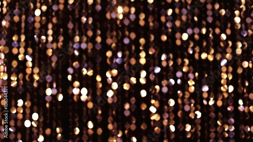 Abstract glittering lights, gold background, a real shot video in the blur