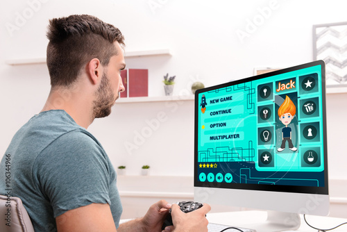 Young man playing computer ...