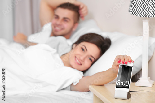Happy couple waking up with...