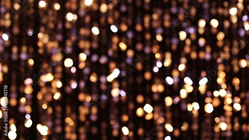Abstract glittering lights, gold background, a real shot video in the blur