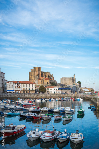 Port of Castro Urdiales. In the background the church of Santa Maria de la Asuncion, the lighthouse of the Castle of Santa Ana and the medieval bridge